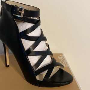 Michael Kors, leather  those in black size 7 1/2 medium with zipper in the back.